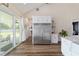 Kitchen with stainless refrigerator, white cabinets, island with white countertop, and sliding glass door to yard at 13663 Sw 66Th St, Ocala, FL 34481