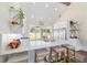 Kitchen island featuring quartz countertops, a farm sink, and seating, illuminated by recessed lighting at 13663 Sw 66Th St, Ocala, FL 34481