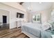 Main bedroom featuring vaulted ceilings, chandelier, wood floors, dresser, windows, and ensuite bathroom at 13663 Sw 66Th St, Ocala, FL 34481