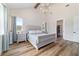 Main bedroom boasts vaulted ceiling, chandelier, and ensuite bathroom with walk-in closet at 13663 Sw 66Th St, Ocala, FL 34481