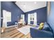 Contemporary office with vaulted ceilings, wood floors, blue walls, white trim, and a ceiling fan at 13663 Sw 66Th St, Ocala, FL 34481