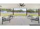 Inviting covered patio with comfortable seating, perfect for outdoor relaxation and entertaining with a view of the backyard at 13663 Sw 66Th St, Ocala, FL 34481
