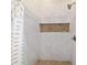 Close-up of the tiled shower with a built-in niche, showcasing the high-end finishes and attention to detail at 13663 Sw 66Th St, Ocala, FL 34481