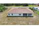 Aerial view of a home with a neutral color scheme, rear patio, and a large yard space at 14550 Sw 61St Ct, Ocala, FL 34473