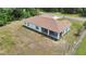Aerial view showcases backyard, and covered patio of this home, surrounded by plenty of green space at 14550 Sw 61St Ct, Ocala, FL 34473