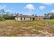The backyard features a large grassy area and mature trees at 14550 Sw 61St Ct, Ocala, FL 34473