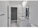 Bright bathroom with double sink vanity, marble countertop and grey accent wall at 14550 Sw 61St Ct, Ocala, FL 34473