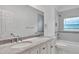 Bright bathroom with double sink vanity and tub with tile surround at 14550 Sw 61St Ct, Ocala, FL 34473