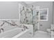 Modern bathroom with a tub and a glass-enclosed shower with marble-like tile at 14550 Sw 61St Ct, Ocala, FL 34473