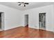 Bright bedroom features a ceiling fan and gleaming hardwood floors at 14550 Sw 61St Ct, Ocala, FL 34473