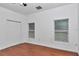Bright bedroom with hardwood floors, closet, and natural light from two windows at 14550 Sw 61St Ct, Ocala, FL 34473