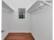 Walk-in closet features built-in shelving and a small window at 14550 Sw 61St Ct, Ocala, FL 34473