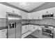 Modern kitchen with stainless fridge and updated cabinetry at 14550 Sw 61St Ct, Ocala, FL 34473