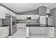 Modern kitchen with stainless appliances, white cabinetry, island at 14550 Sw 61St Ct, Ocala, FL 34473