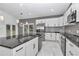 Modern kitchen boasts an island and stainless steel appliances at 14550 Sw 61St Ct, Ocala, FL 34473
