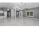 Bright living room with marble floors connects to kitchen at 14550 Sw 61St Ct, Ocala, FL 34473