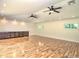 Finished basement with recessed lights, wood-look flooring, built-in cabinets, and two windows at 1610 Se 22Nd Ave, Ocala, FL 34471
