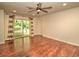 Bedroom with sliding glass doors to the patio and wood-look floors and a ceiling fan at 1610 Se 22Nd Ave, Ocala, FL 34471