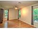 Bright bedroom with wood floors, two windows, curtains and a ceiling fan at 1610 Se 22Nd Ave, Ocala, FL 34471