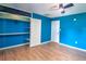 Bright bedroom features hardwood floors, ceiling fan, and closet with built-in shelves at 1610 Se 22Nd Ave, Ocala, FL 34471