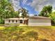 Front exterior view of the home showcasing its modern design, attached garage, and well-manicured front yard at 1610 Se 22Nd Ave, Ocala, FL 34471