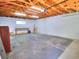 Spacious garage with unfinished walls, exposed ceiling, window, and concrete floor ready for customization at 1610 Se 22Nd Ave, Ocala, FL 34471