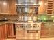 Gourmet kitchen featuring a stainless steel range hood, granite countertops, and wine rack at 1610 Se 22Nd Ave, Ocala, FL 34471