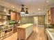 Open kitchen with stainless steel appliances, island, and view of the living areas at 1610 Se 22Nd Ave, Ocala, FL 34471