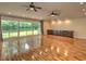 Spacious living room with wood floors, custom cabinets, and a large picture window overlooking the backyard at 1610 Se 22Nd Ave, Ocala, FL 34471
