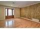 Bright living room featuring wood floors, a decorative wood wall, and recessed lighting at 1610 Se 22Nd Ave, Ocala, FL 34471