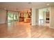 Open-concept living area with wood floors, sliding glass doors, and kitchen view at 1610 Se 22Nd Ave, Ocala, FL 34471