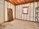 Interior of the unfinished shed showcasing a window, wall studs, and concrete floor ready for customization at 1610 Se 22Nd Ave, Ocala, FL 34471