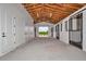 Spacious barn featuring high wood ceilings, bright lighting, and multiple stalls for horses or livestock at 1631 W Hwy 329, Citra, FL 32113