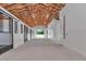 Well-lit barn interior with concrete floors and multiple stalls, providing ample space for animals and equipment at 1631 W Hwy 329, Citra, FL 32113