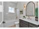 Updated bathroom with modern vanity, gold fixtures, and tiled shower/tub at 1631 W Hwy 329, Citra, FL 32113