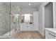A modern bathroom is designed with tile-lined walls, glass-enclosed shower, and modern vanity with gold accents at 1631 W Hwy 329, Citra, FL 32113