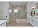 Modern bathroom designed with glass-enclosed shower, tile-lined walls, and vanity with gold accents and fixtures at 1631 W Hwy 329, Citra, FL 32113