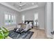 Beautiful bedroom features a modern ceiling fan, two windows, and a comfortable bed with a stylish bench at 1631 W Hwy 329, Citra, FL 32113