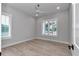 Sunlit bedroom with wood-look floors, white trim, and a ceiling fan at 1631 W Hwy 329, Citra, FL 32113