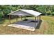 Functional covered structure with sturdy beams on a concrete slab, ideal for storage or equipment shelter amidst verdant landscaping at 1631 W Hwy 329, Citra, FL 32113