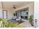 Covered patio with seating, plants and view to the main house at 1631 W Hwy 329, Citra, FL 32113
