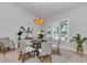 Dining room with large windows, shutters, modern chandelier, and seating for six at 1631 W Hwy 329, Citra, FL 32113