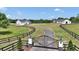 Grand gated entrance to a scenic estate with fenced pastures and two well-appointed homes at 1631 W Hwy 329, Citra, FL 32113