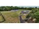 Scenic ranch estate with a private drive, fenced acreage, a white farmhouse, and a secondary building at 1631 W Hwy 329, Citra, FL 32113