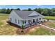 Stunning property features a lovely home with a welcoming front porch and charming landscaping details at 1631 W Hwy 329, Citra, FL 32113