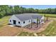 Rear exterior view of a modern home with a covered porch and nicely landscaped yard at 1631 W Hwy 329, Citra, FL 32113