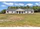 Charming single-story home with a lush green lawn, landscaping, and a welcoming front porch at 1631 W Hwy 329, Citra, FL 32113
