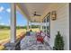 Welcoming covered porch boasting ceiling fans and an inviting seating area with views at 1631 W Hwy 329, Citra, FL 32113