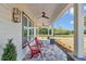 Comfortable covered porch with ceiling fans and stylish seating area at 1631 W Hwy 329, Citra, FL 32113