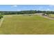Wide aerial shot showcasing large open fields, and a residence, with a view of the surrounding countryside at 1631 W Hwy 329, Citra, FL 32113